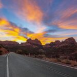 Sunset over a scenic road through Sedona's red rocks