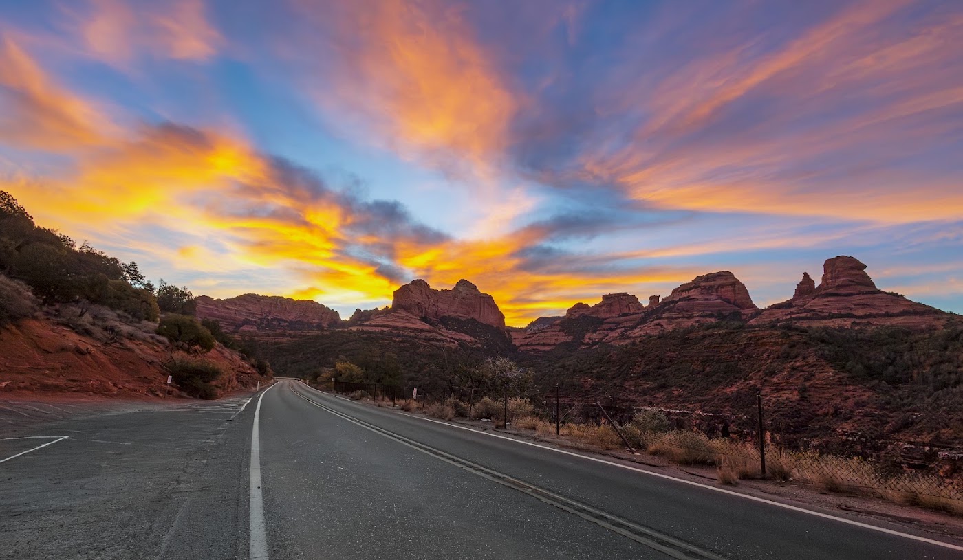 Sunset over a scenic road through Sedona's red rocks
